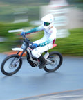 Adult Electric Dirt Bike Built To Shred With Raw Torque And 53 MPH Top Speed racing on a dirt path, showcasing speed and agility.