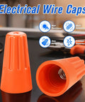 Two orange plastic insulated wire caps for electrical wiring (wire nuts)