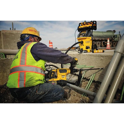 Worker using Pro Grade SDS Max Hollow Drill Bit 7 by 8 Inch with Dust Shroud, efficient dust removal in concrete drilling site