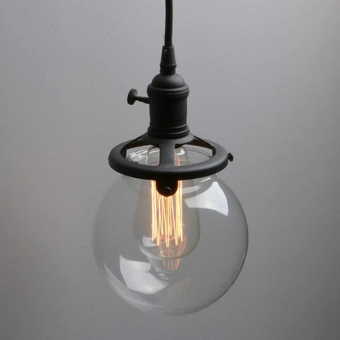 Close-up of Three Light Industrial Cluster Pendant Ceiling Fixture With 5.9 Inch Clear Globe Shades In Black Finish For Foyer Entryway High Ceiling.