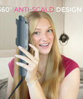 Woman using Automatic Rotating Curling Iron for Effortless Beachy Waves, CurlPRO Wand With Ionic Technology in home setting.
