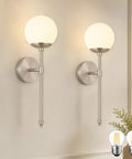 KoKo&Yukina 2 Pack Nickel Mid Century Wall Sconce Bedroom Bulb Included with milk white globes mounted on a wall.
