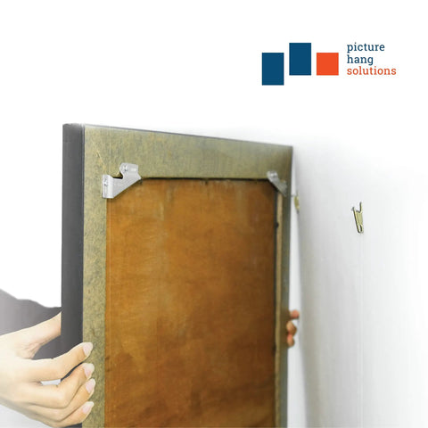 Rock Solid Self Leveling Sawtooth Picture Frame Wall Hangers For Wood Art Displays With No Hassle Easy Install Hardware Kit Holds Up To Thirty Pounds Super Legit Five Piece Set, showing installation of wall hanger on a frame.