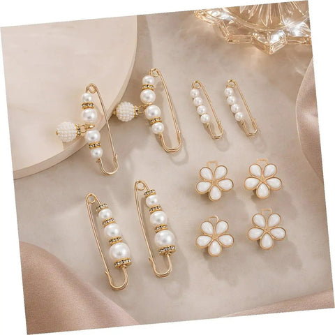 Eight Piece Pearl Waist Tightener Pins With Secure Locking Buckle System Fixes Loose Jeans And Skirts Instantly No Sew Hidden Dress Clips set with gold accents and pearls.