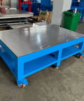 Rock Solid No Nonsense Heavy Duty Workbench For Welding And Metal Fabrication With 8mm Thickened Steel Plate on blue frame with wheels.