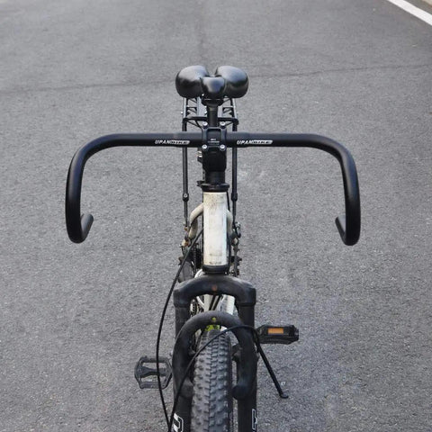 Front view of drop bar bent handlebar aluminum alloy 6061 T6 on road bike showcasing 25.4mm and 31.8mm clamp compatibility.