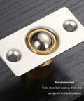 Close-up of Solid Brass Door Ball Catch Set With 4 Adjustable Spring Closet Latches for cabinets and pantries on black surface.