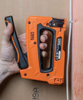 Person using Heavy Duty Cable Stapler Built Tough For Voice Data Video And Nonmetallic NM Cable on wall with insulated staples