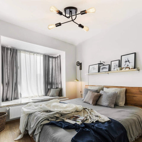 Industrial Semi Flush Mount Four Light Ceiling Fixture With Adjustable Black Metal Branches in a modern bedroom setting.