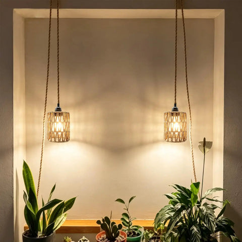 Amp Up Your Space With This Straight Up Badass Boho Pendant Light Featuring A Heavy Duty 16.5 Ft Plug In Swag Cord And Handwoven Rattan Cylinder Shade For Zero Hassle Setup And Chill Room Vibes, hanging above plants.