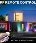 Modern house lit with Six Pack RGBW In Ground Landscape Lights With Remote, LED well lights highlighting facade at night.