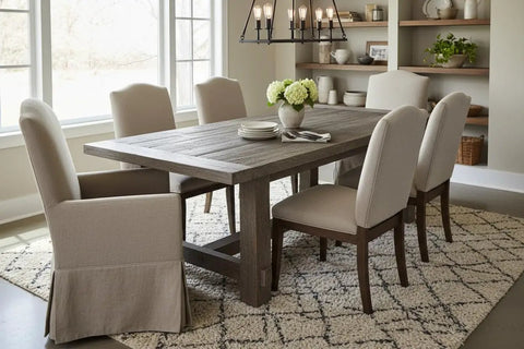 Heritage Gray Reactive Water Based VOC Free Interior Wood Stain 55 Gallon Tank on rustic dining table with beige chairs.