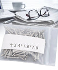 Durable Eyeglasses Hinge Screws Kit For Quick Fixes, Metal Repair Pins in a plastic bag on desk with eyeglasses.