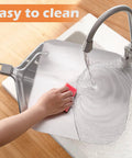 Person cleaning aluminum peel from Must Have Pizza Peel Set With Cutter Rocker, Aluminum Peel, Foldable Handle under running faucet