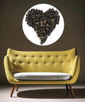 Premium 320 Piece Set Of Top Shelf Upholstery Tacks Featuring A Knockout Antique Brass Finish arranged in a heart shape above a yellow sofa.