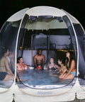 Group in a Lightweight Pop Up Screen Room Tent For 4 To 6 Adults, enjoying a hexagon outdoor canopy with mesh walls at night.
