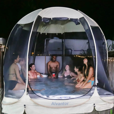 Group in a Lightweight Pop Up Screen Room Tent For 4 To 6 Adults, enjoying a hexagon outdoor canopy with mesh walls at night.