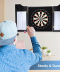 Person playing with Solid Wood Classic Dartboard Cabinet Set With Bristle Dartboard, Built In Scoreboard, 6 Steel Tip Darts