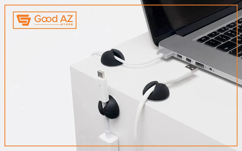 Self Adhesive Black Silicone Cable Clips Organizer Pack Of Six For USB Charging And Network Cables shown on white desk with laptop.
