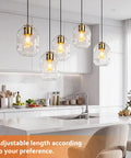 3 Pack Gold Pendant Lights For Kitchen Island Featuring 8.7 Inch Hand Blown Clear Art Glass Globes over a modern kitchen island.