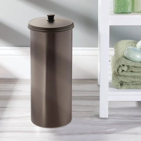 Freestanding bronze round bathroom container beside towels and bath products