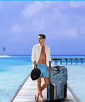 Man with Big Mesh Beach Bag With Zipper Pockets Foldable Duffle on pier by ocean, ideal for scuba and snorkel gear, outdoor adventures.