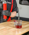 ARES 54036 bearing packer kit: red grease gun with hose connected to cone-style bearing packer over a clear grease cup.