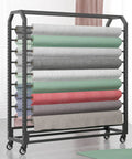 Hella Durable Adjustable Steel Rolling Shelf For Bulk Vinyl Wallpaper And Window Film Storage Featuring Smooth Riding Casters holding various rolls of vinyl.