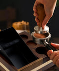Sleek Espresso Knock Box Bundle Featuring A Rock Solid Wood Tamping Station And Heavy Duty Coffee Tamping Stand in use with tamper.
