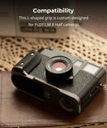 Fujifilm X Half L Shaped Grip With Built In Quick Release Plate For Arca attached to camera on table