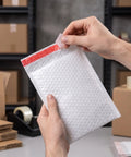 Hands sealing 30 Pack 6 By 8 Inch Bubble Mailers Self Seal Envelopes Waterproof Protective Mailing Bags With Bubble Cushion For Safe Shipping