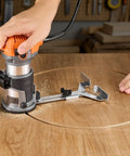 Heavy Duty One Horsepower Wood Router And Palm Edge Trimmer With Variable Speed Control From Ten Thousand To Thirty Two Thousand RPM Plus Four Inch Plunge Travel and Three Swap Bases in use on wood.