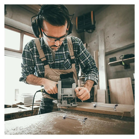 Man cutting wood in workshop with Countertop Joiner Connectors Set 10 Pcs 150mm Benchtop Drawbolt Bolts visible on table