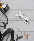 Built Tough Stainless Steel Box Truck Hinges Cargo Trailer Rear Door Hardware on work surface with tools and tire.