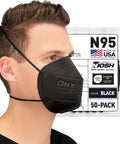 Person wearing NIOSH Approved N95 Respirator Mask Black 50 Pack Made In USA With Overhead Head Straps For A Tight Seal And 95 Percent Filtration Of Non Oil Based Particles 0.3 Micron Model H95B, packaging visible