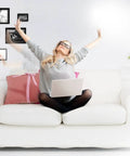 Woman using laptop on white sofa with cat; Hands Free Z Wave Gesture Controller for Smart Homes, No Touch Swipe Pad in background.