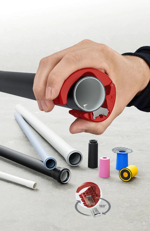 Hand using Pipe Cutter For Plastic Pipes 20 To 50 mm That Cuts Without Shavings, Ergonomic Handle near various pipes and spare blades