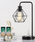 Industrial Dual USB Desk Lamps Set of 2 with Edison style bulb, black metal cage, built-in AC outlet on tabletop, charging phones.