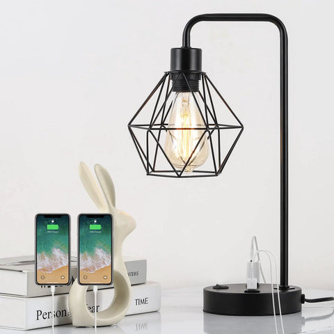 Industrial Dual USB Desk Lamps Set of 2 with Edison style bulb, black metal cage, built-in AC outlet on tabletop, charging phones.