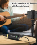 Guitar Audio Interface Plug And Play Portable Recording Sound Card For Live Streaming On IPhone Ipad And Android Phones And Tablets No Driver Needed OTG Ready shown in use with smartphone and guitar