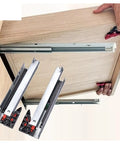 Heavy Duty Undermount Concealed Drawer Slides Featuring Hella Smooth Glide Motion And Professional Grade Steel Construction For Kitchens And Workshops Built Tough Without Any Exposed Mounting Parts 1 Pair being installed in a wooden drawer.