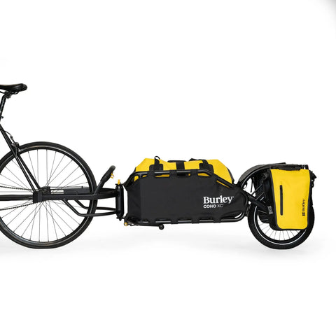 Coho XC Single Wheel Off Road Cargo Bike Trailer with coil spring suspension attached to bike, slim profile for narrow trails.