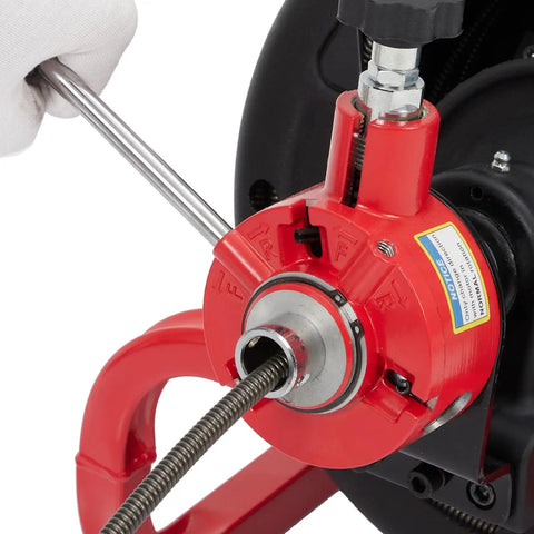 Built Tough Auto Feed Electric Drain Auger showing steel cable mechanism with red housing and controls for drain clearing.