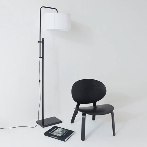 Mid Century Modern Floor Lamp With Ultra Stable Heavy Base And LED Lighting For Bedroom Living Room Or Office Sleek Black Contemporary Standing Lamp That Brings A Clean Cozy Vibe To Any Modern Decor next to black chair.