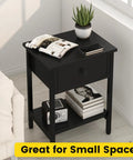 Totally Legit Nightstands Set Of 2 With Deep Drawers And Open Storage Shelf Made From Heavy Duty Wood And Powder Coated Alloy Steel Legs Rock Solid Side Tables For Bedroom Or Living Room Smooth Snap Together Assembly Glossy Black with magazines, plant, and phone on top.