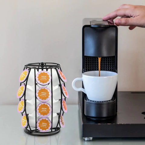 Rotating K Cup Holder Carousel For Countertop Holds 20 Coffee Pods next to coffee maker with pod brewing into cup.