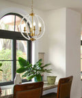 Modern Four Light Pendant Chandelier With Clear Acrylic Globes And Brass Finish In Dope Farmhouse Style for kitchen island.