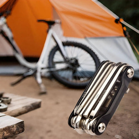 All In One Carbon Steel Bike Multi Tool For Road And Mountain Bikes With 12 Precision Tools beside a tent and bike