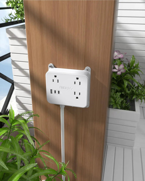 Flat Plug Power Strip With USB Ports And 3 Widely Spaced Outlets mounted on wall with 5ft extension cord, white design.