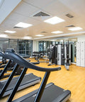 Modern gym interior with equipment and lockers for exercise and storage.